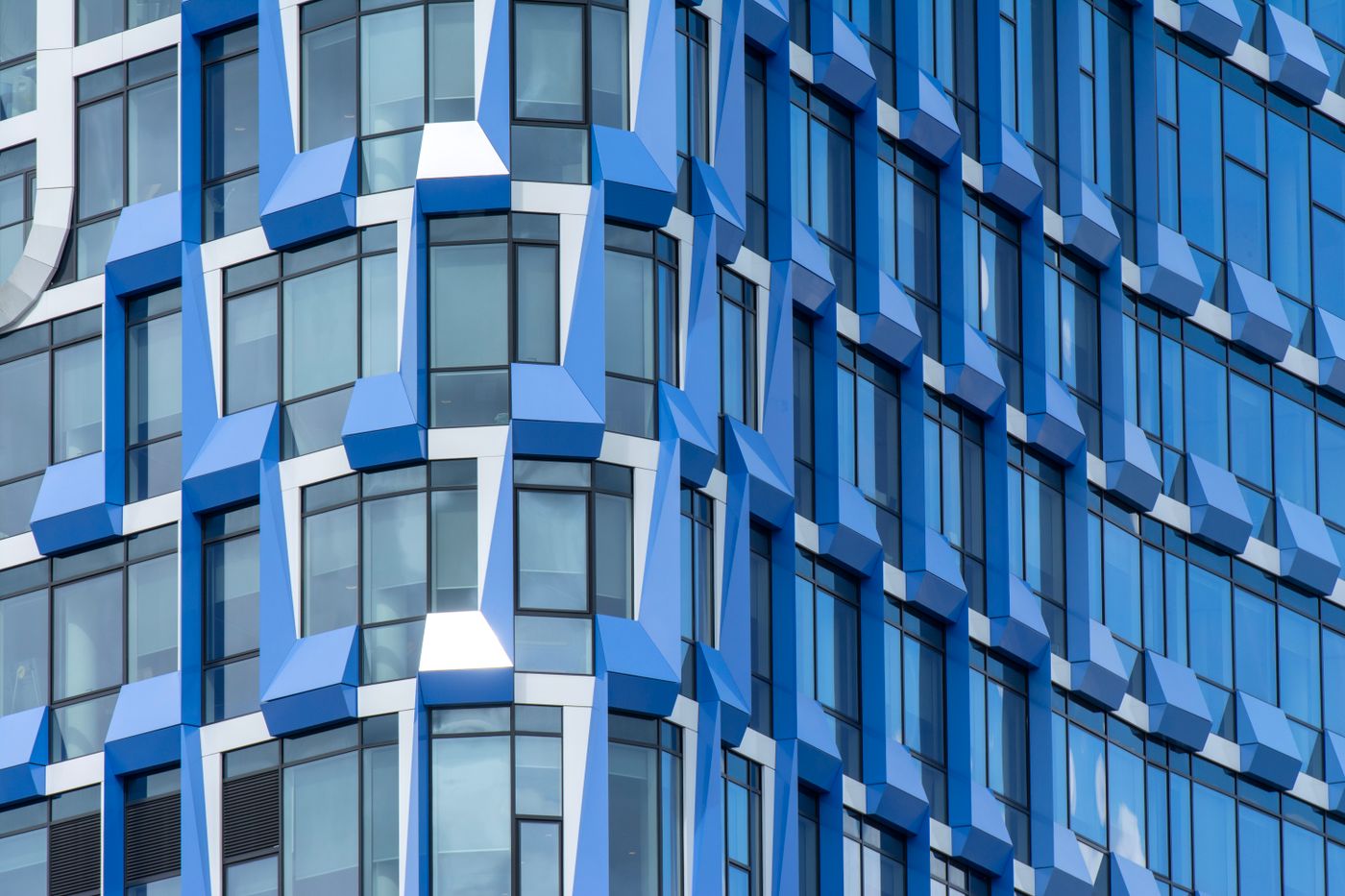 Geometric blue facade in Amsterdam, used in a fictional architecture website concept